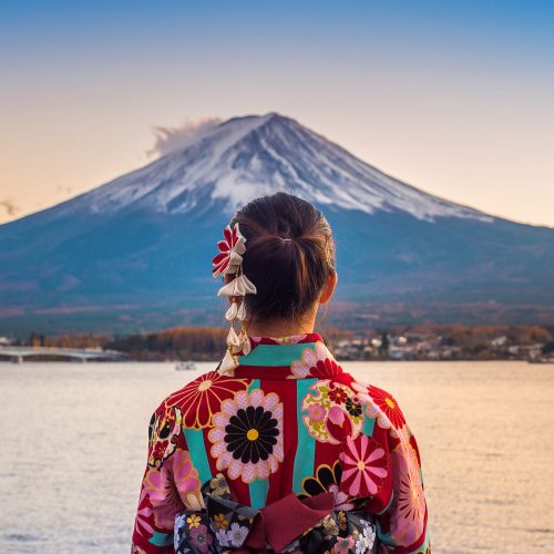 Asian woman wearing japanese traditional kimono at Fuji mountain. Sunset at Kawaguchiko lake in Japan.